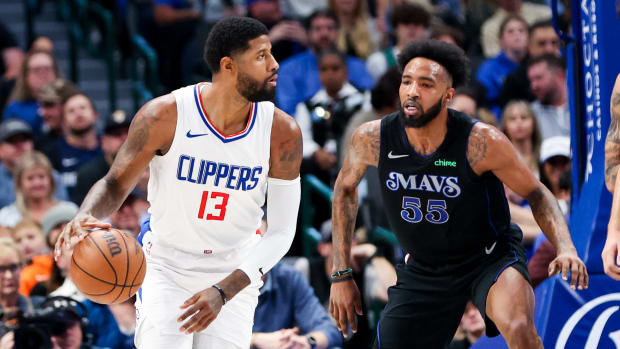 Mavs' Derrick Jones Jr. defends Clippers' Paul George in the post.